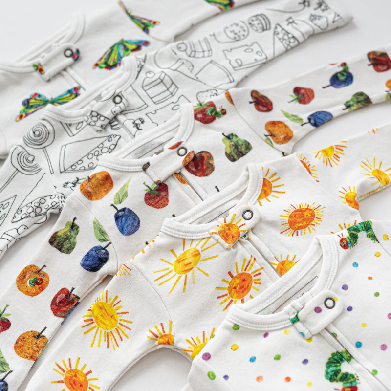 A flatlay of five outfits from the L'ovedbaby® x The Very Hungry Caterpillar™ collection.