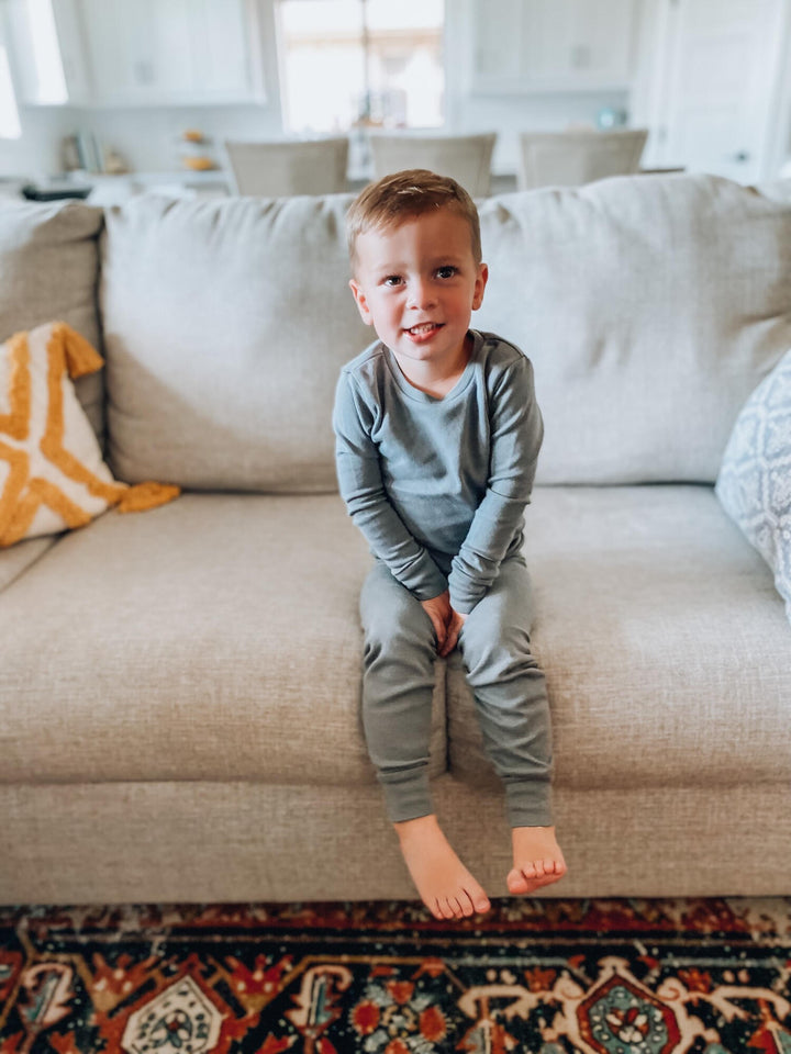 Child wearing Organic Kids' L/Sleeve PJ Set in Gray.