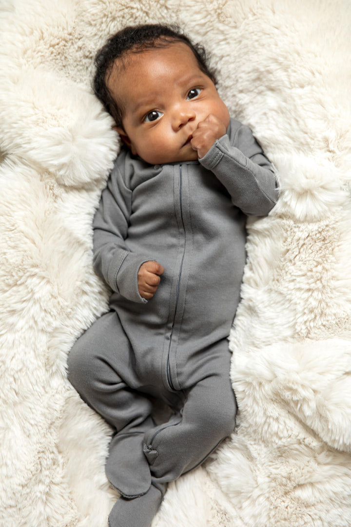 Child wearing Organic 2-Way Zipper Footie in Gray.