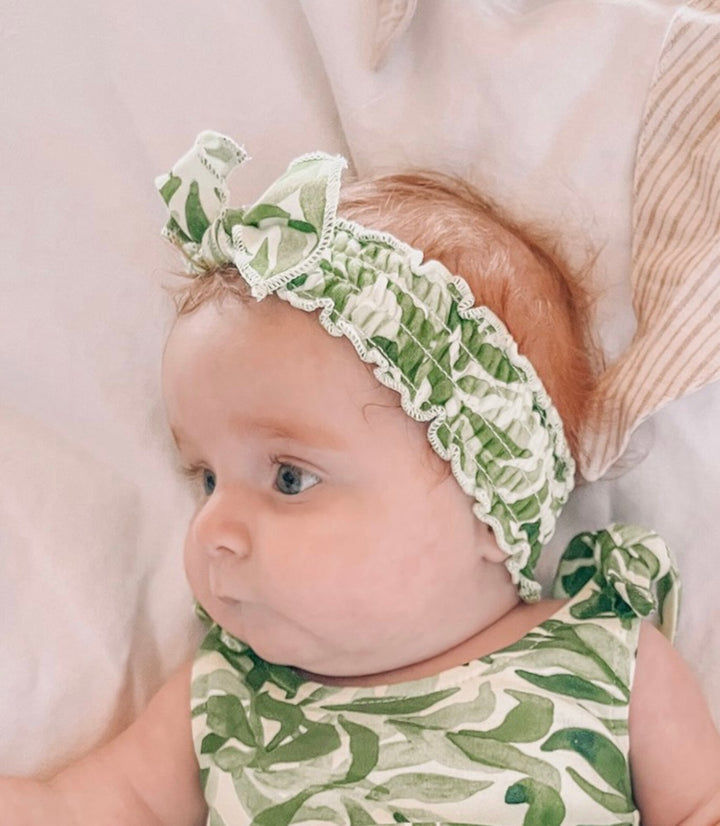 Child wearing Organic Smocked Headband in Kelp.