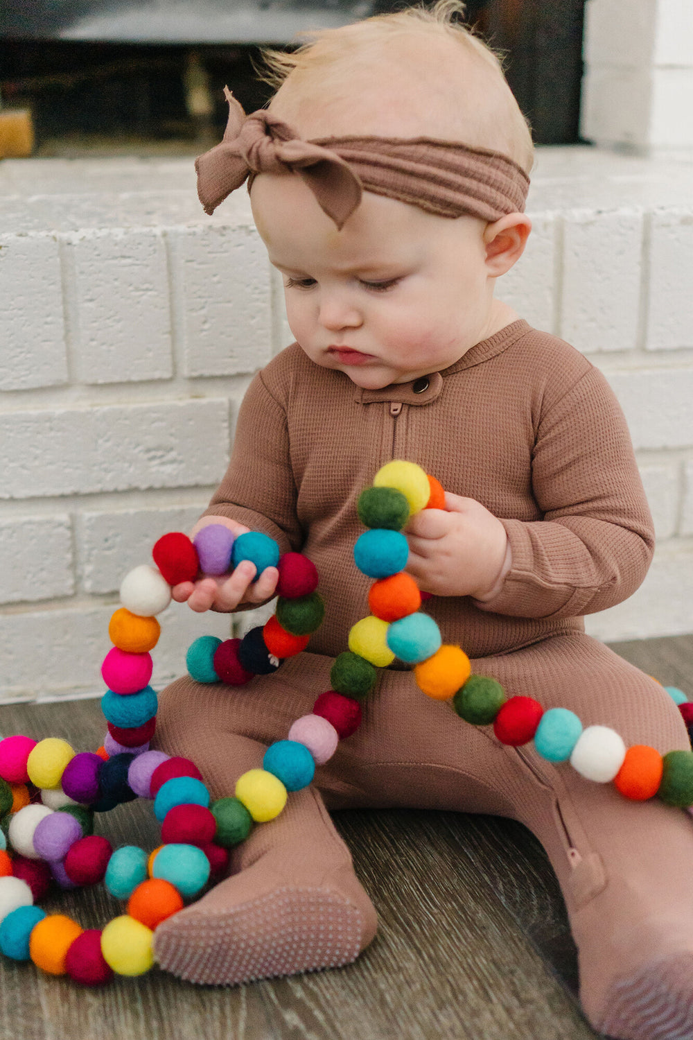 Child wearing Thermal Smocked Headband in Cocoa.