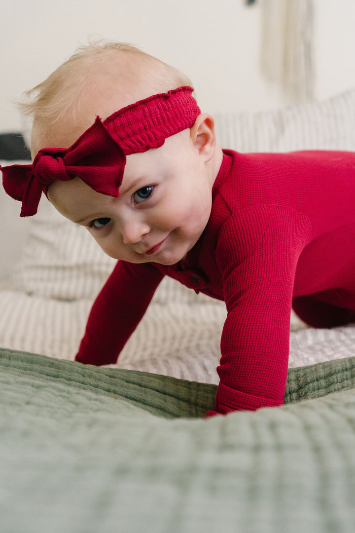 Child wearing Thermal Smocked Headband in Crimson.