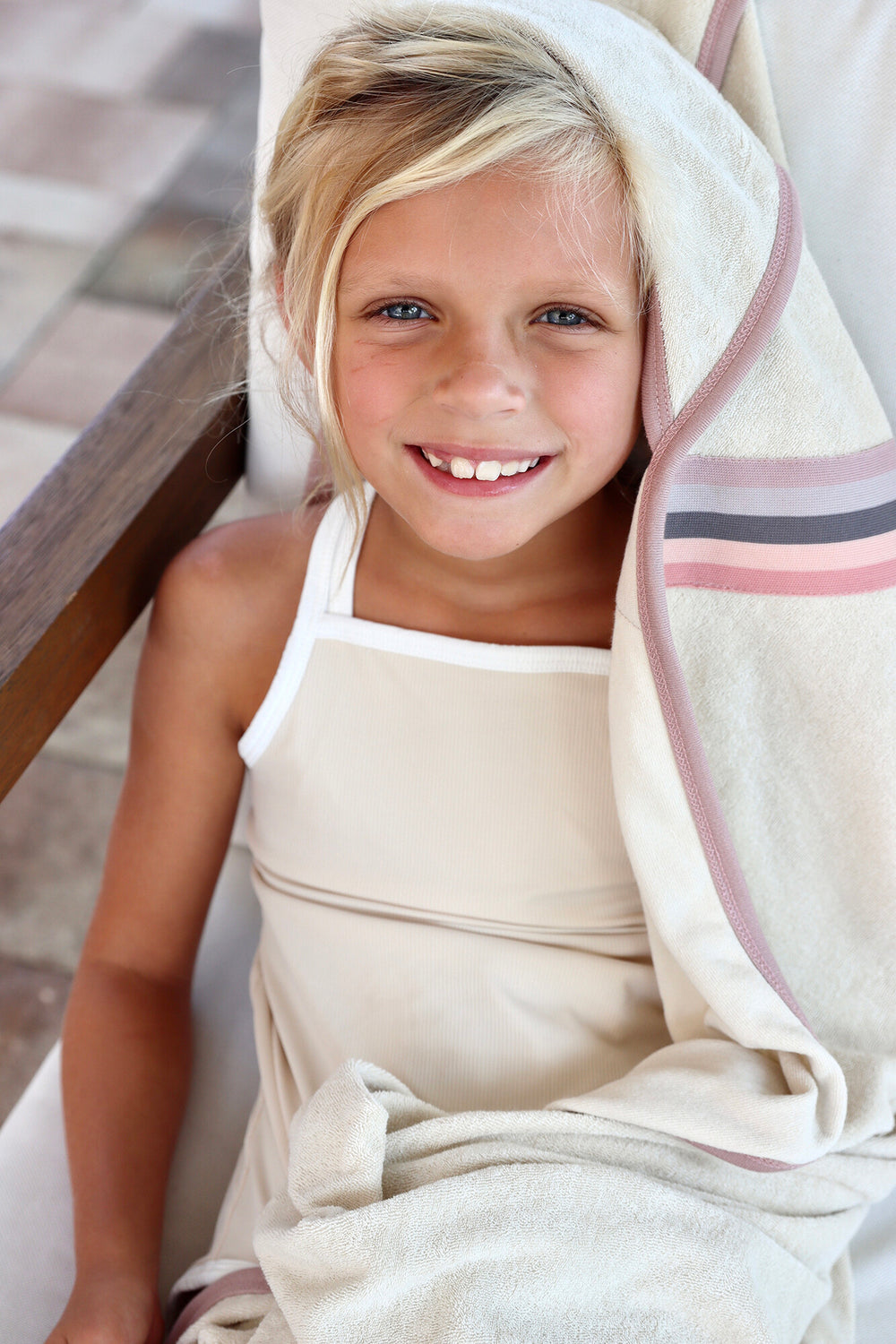 Child wearing Organic Terry Cloth Hooded Towel in Pinks.