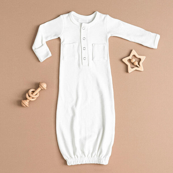 Organic Gown in White on a tan background.