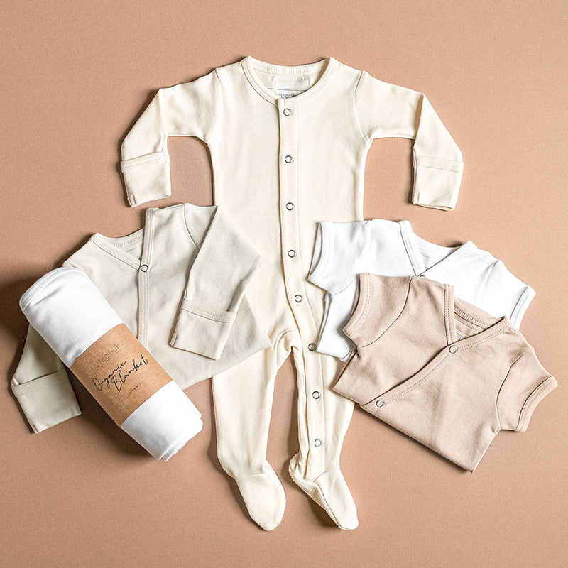 Assorted Organic Cotton Basics styles in shades of white and tan.