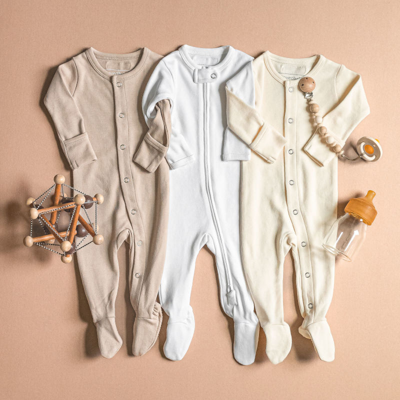 A flatlay of three Organic Footies from the Organic Cotton Basics collection.