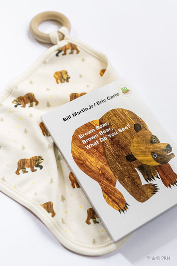 Children's book titled 'Brown Bear, Brown Bear, What Do You See?' by Bill Martin Jr. and Eric Carle on a matching fabric background.