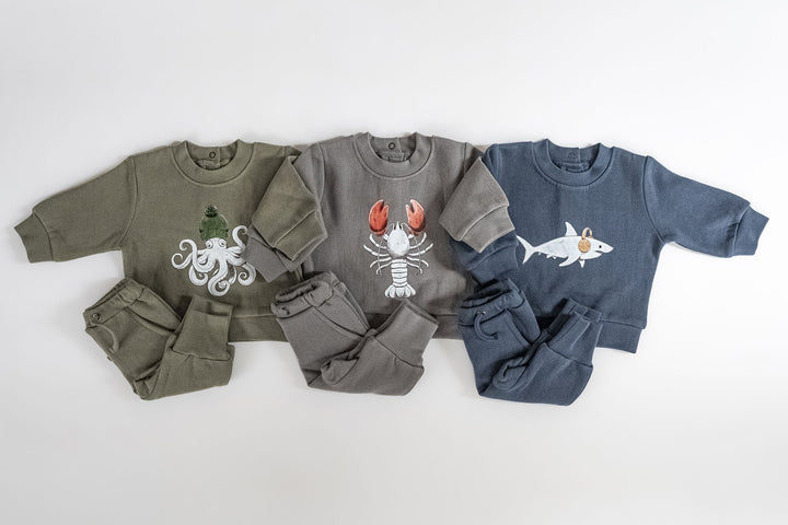 Child wearing Cozy Fleece Crewneck Sweatshirt in Lobster.