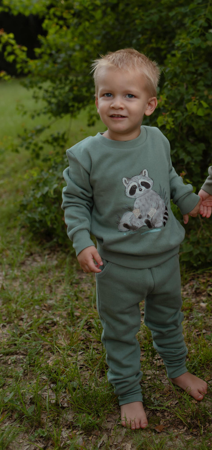 Child wearing Cozy Fleece Crewneck Sweatshirt in Raccoon.