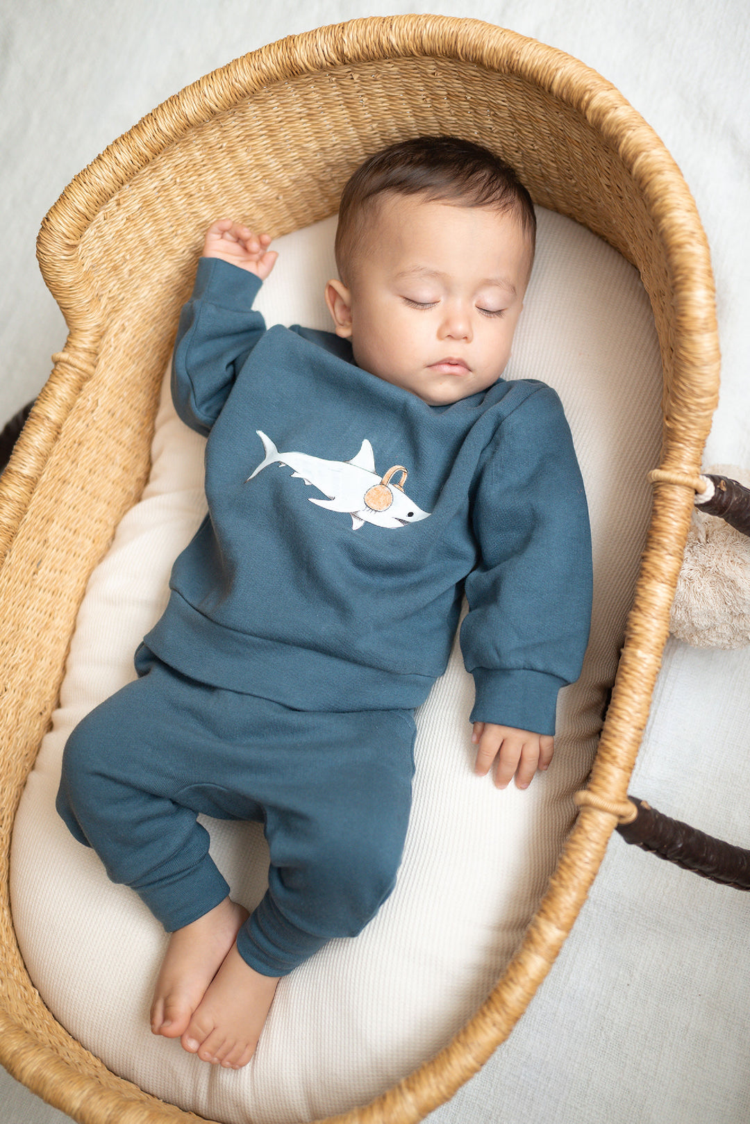 Child wearing a Kids' Cozy Fleece Crewneck Sweatshirt in Sharks.
