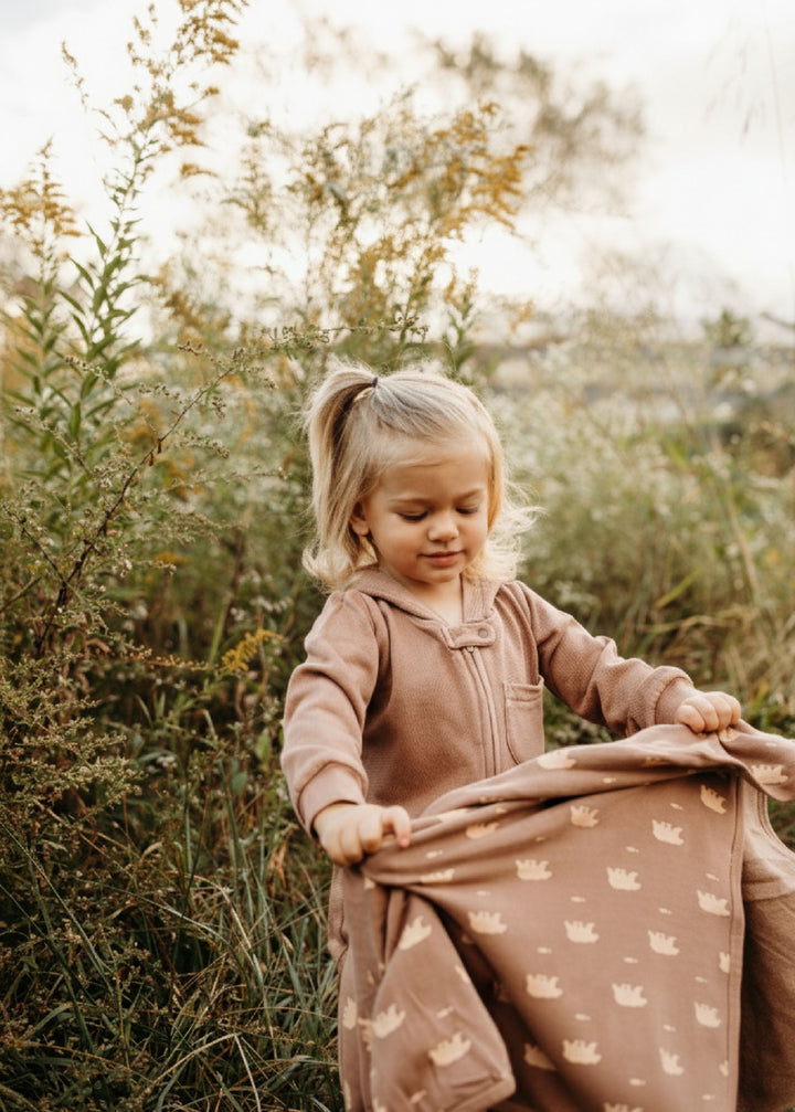 Child wearing Organic Cozy Blanket in Latte Bear.