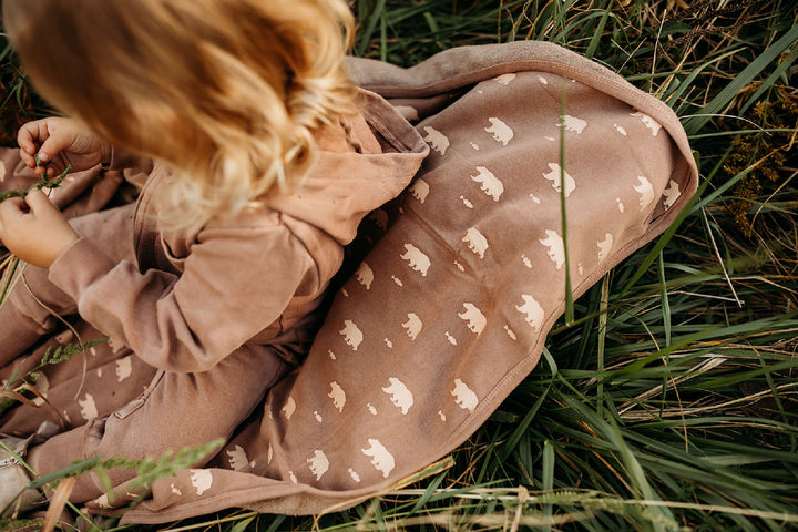 Child wearing Organic Cozy Blanket in Latte Bear.