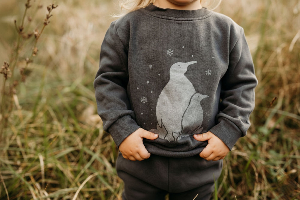 Child wearing Organic Cozy Graphic Sweatshirt & Jogger Set in Coal Penguin.