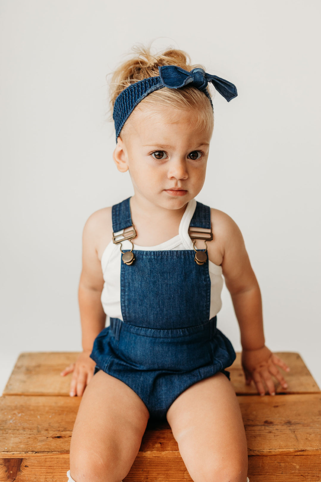 Child wearing Denim Smocked Headband in Denim.
