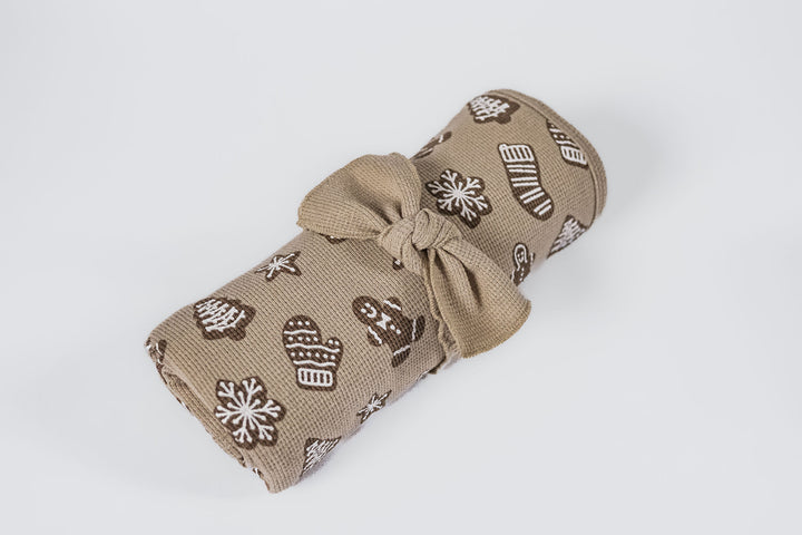 Child wearing Holiday Thermal Blanket in Ginger Glow.