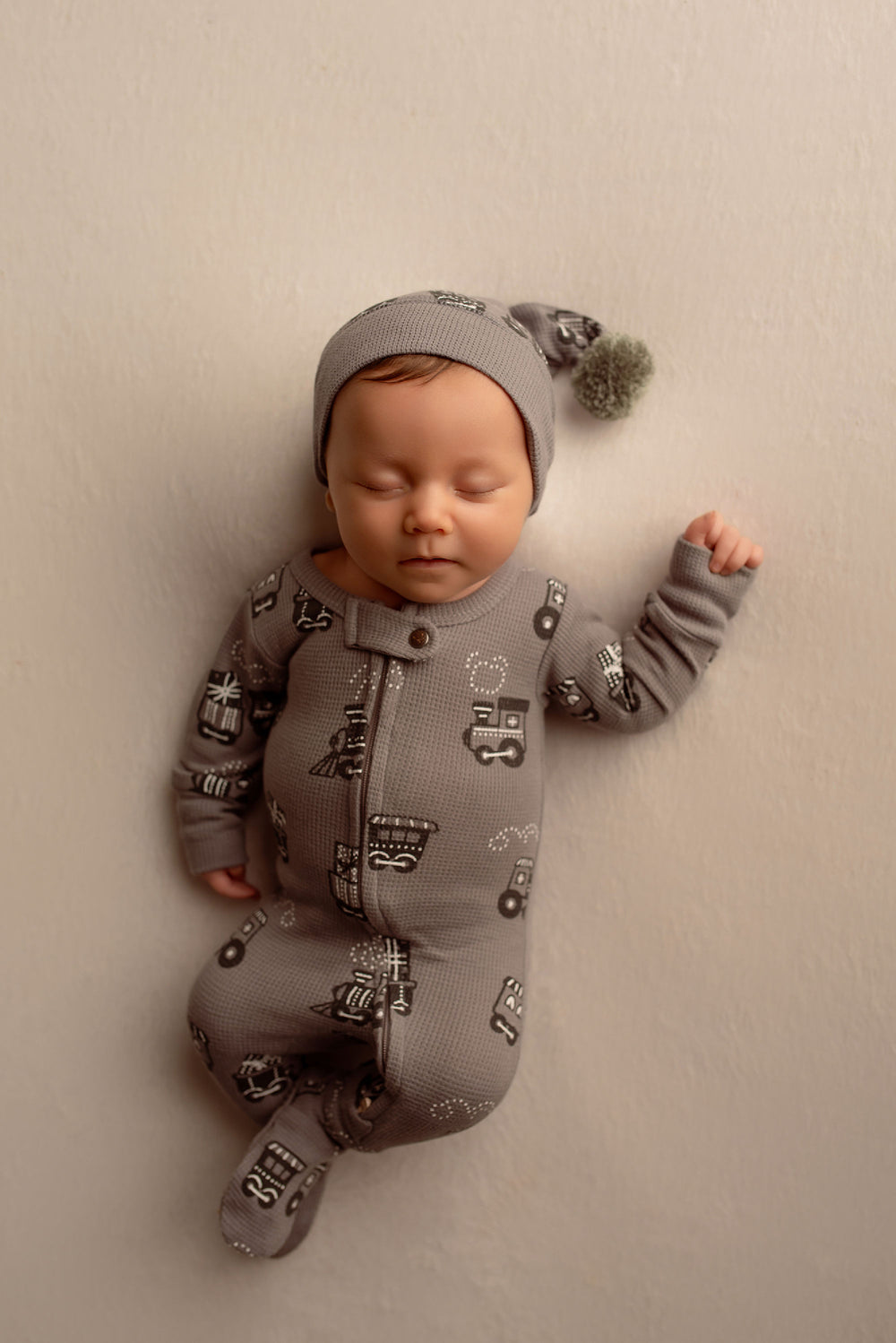 Child wearing Holiday Thermal 2-Way Zipper Footie & Cap Set in Tinsel Train.