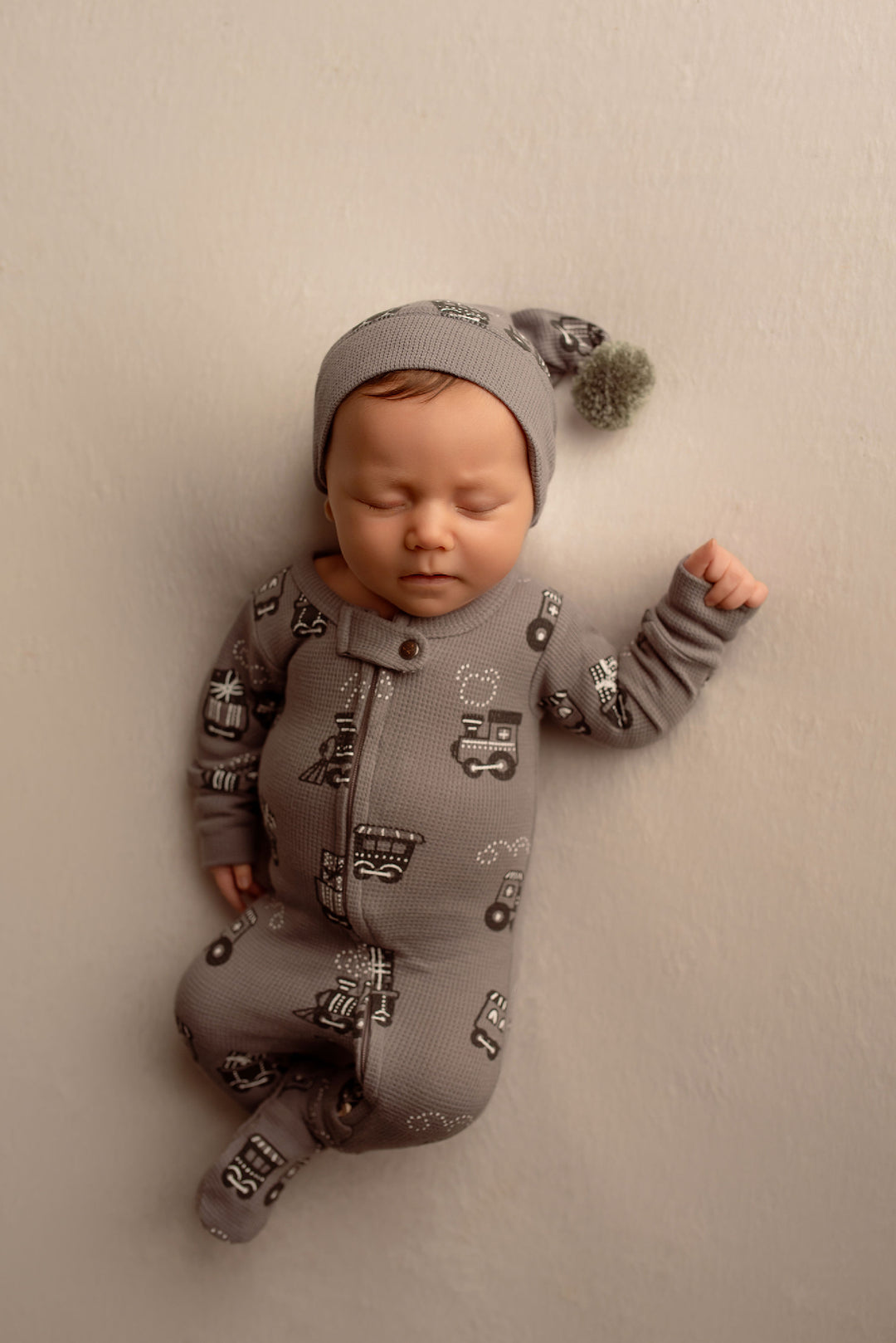 Child wearing Holiday Thermal 2-Way Zipper Footie & Cap Set in Tinsel Train.