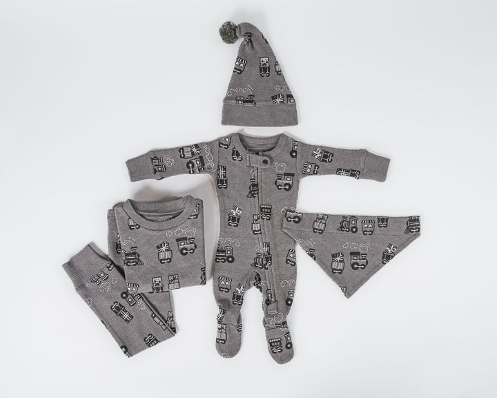 Child wearing Holiday Thermal 2-Way Zipper Footie & Cap Set in Tinsel Train.
