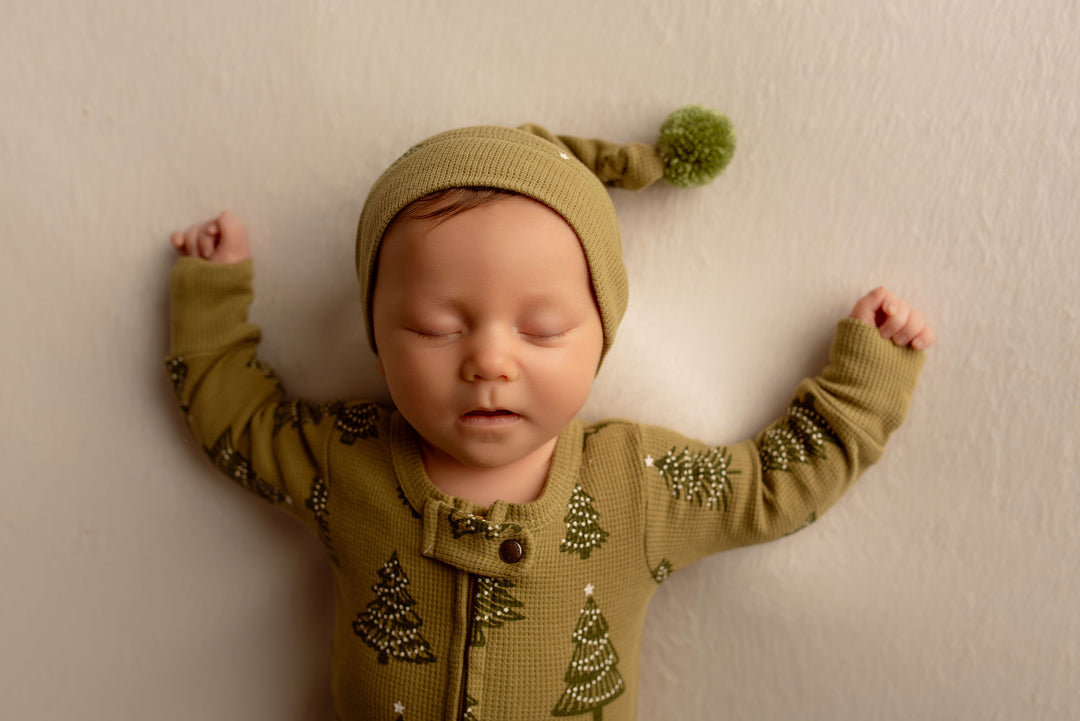 Child wearing Holiday Thermal 2-Way Zipper Footie & Cap Set in Twinkle Tree.