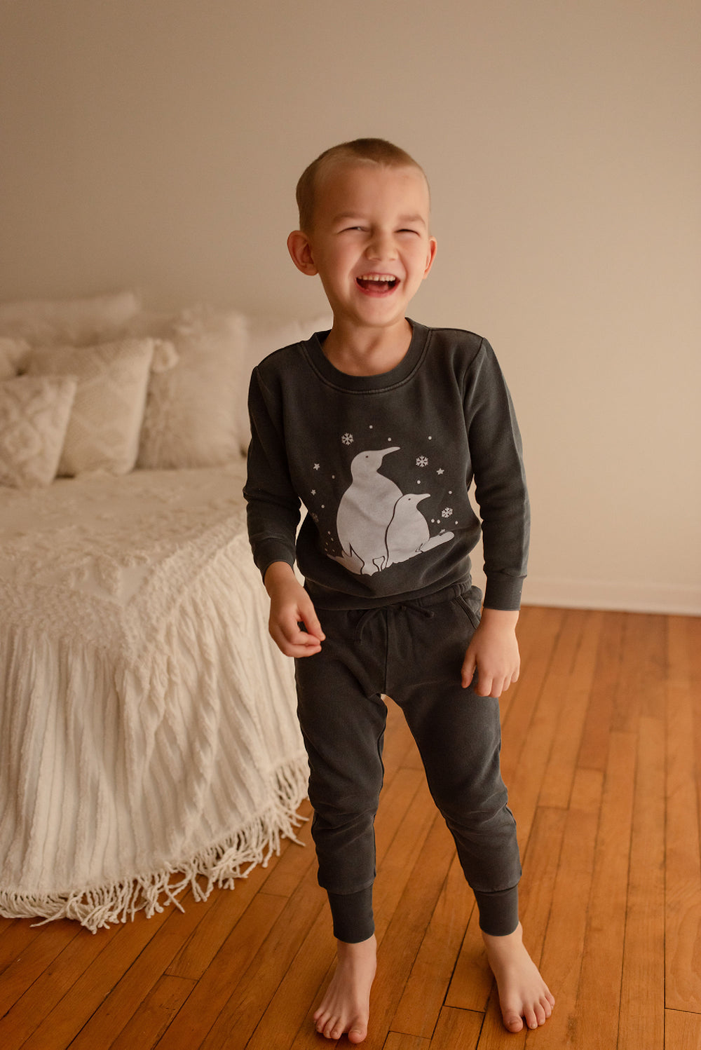 Child wearing Kids' Organic Cozy Graphic Sweatshirt & Jogger Set in Coal Penguin.