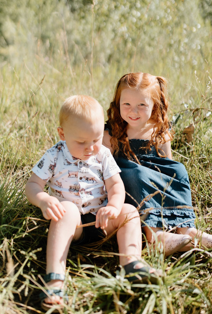 Child wearing Kids' Denim Summer Dress in Denim.
