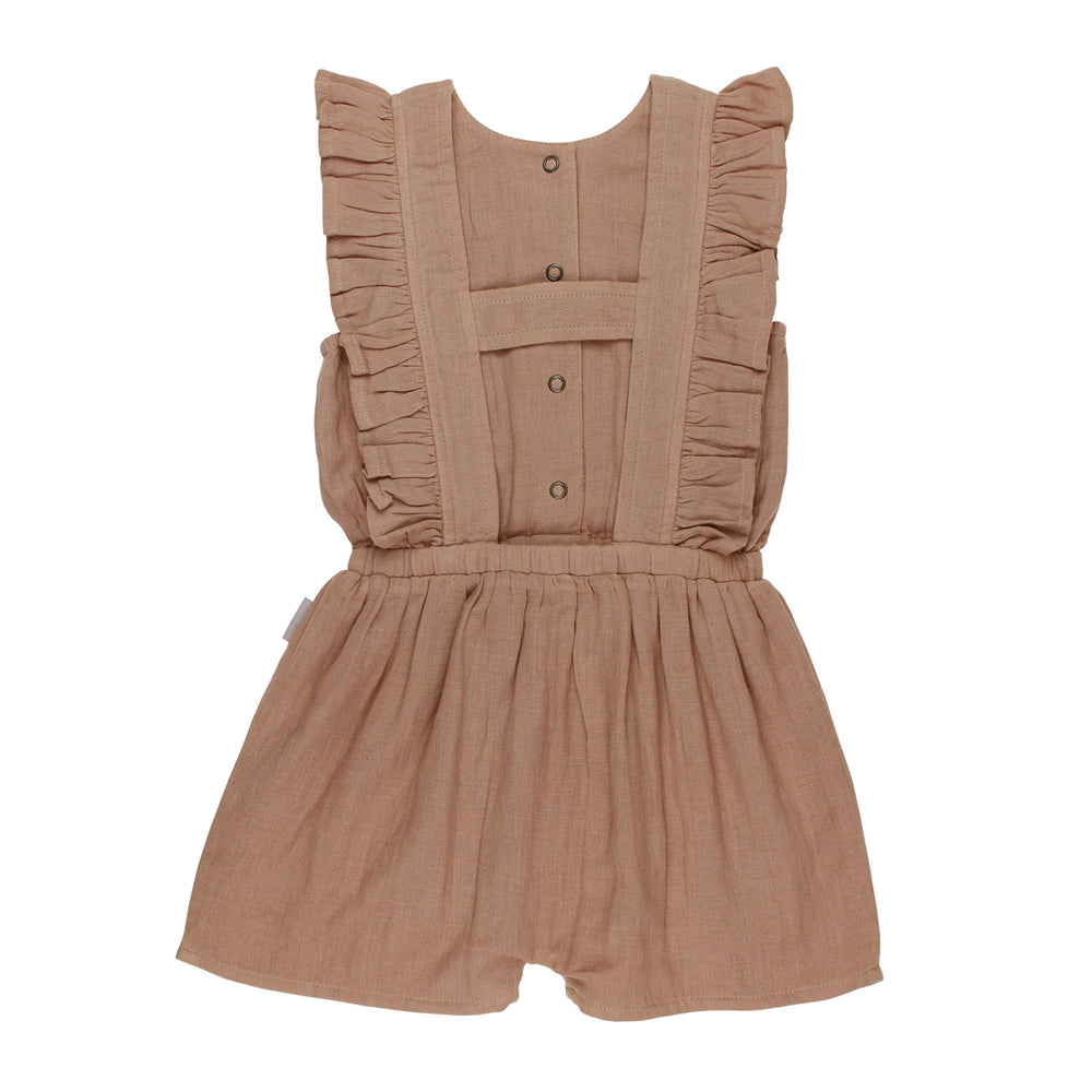 Back view of Kids' Organic Muslin Ruffle Jumper in Adobe, a tan clay color.