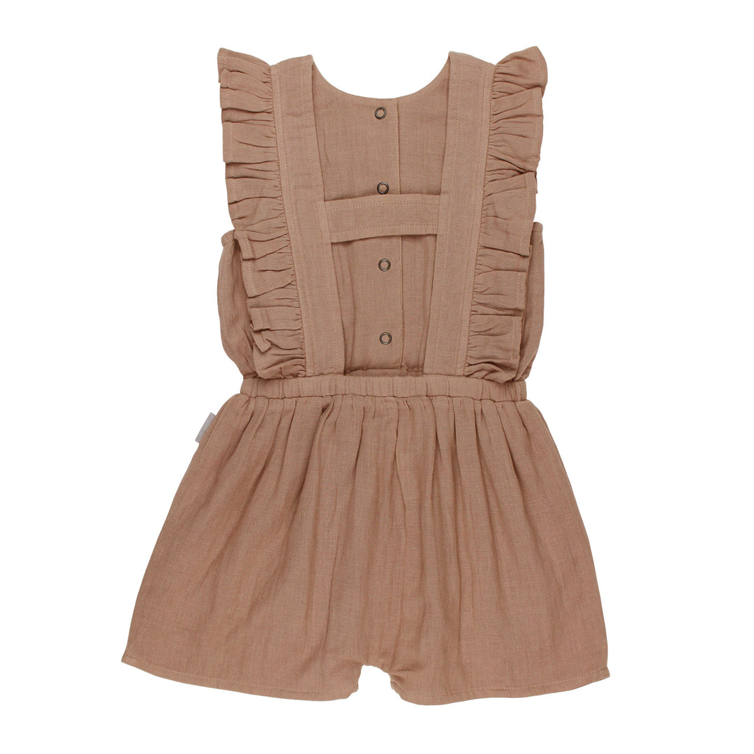 Back view of Kids' Organic Muslin Ruffle Jumper in Adobe, a tan clay color.