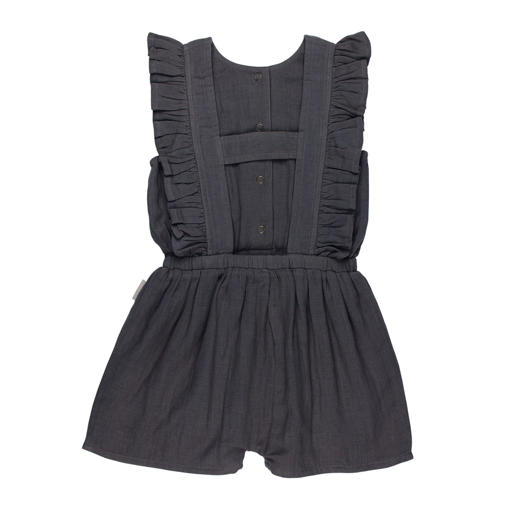 Back view of Kids' Organic Muslin Ruffle Jumper in Chia Seed, a dark gray color.