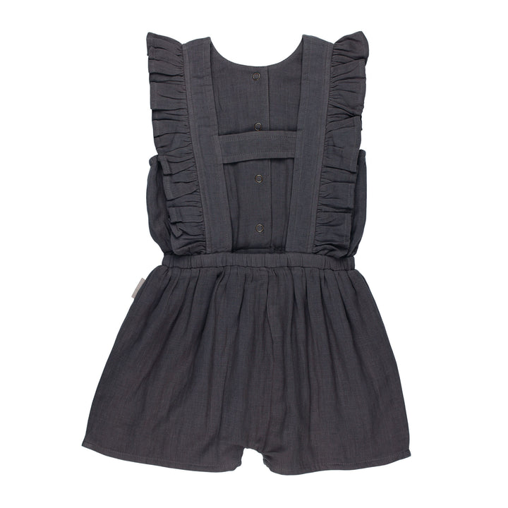 Back view of Kids' Organic Muslin Ruffle Jumper in Chia Seed, a dark gray color.