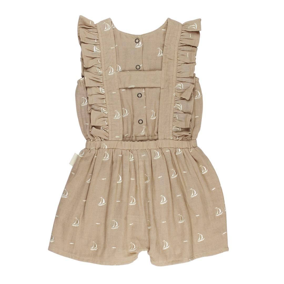 Back view of Kids' Organic Muslin Ruffle Jumper in Oatmeal Sailboat.