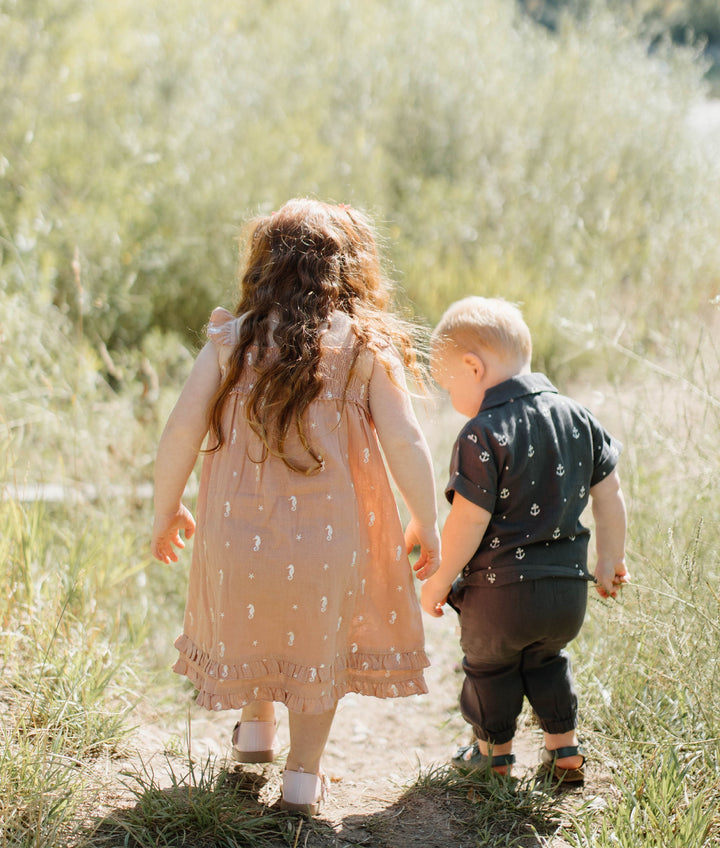Child wearing Kids' Organic Muslin Summer Dress in Adobe Seahorse.