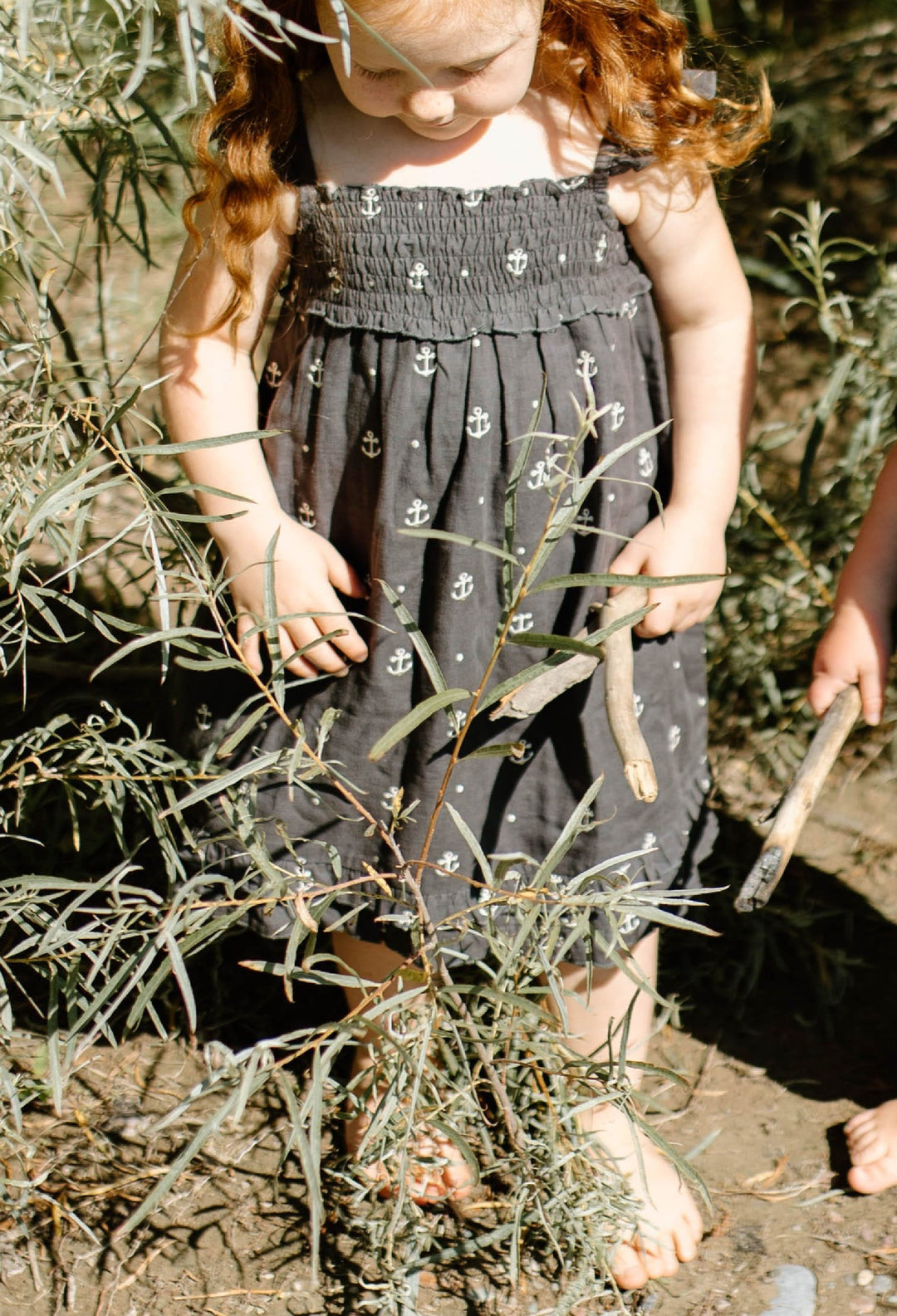 Child wearing Kids' Organic Muslin Summer Dress in Chia Anchor.