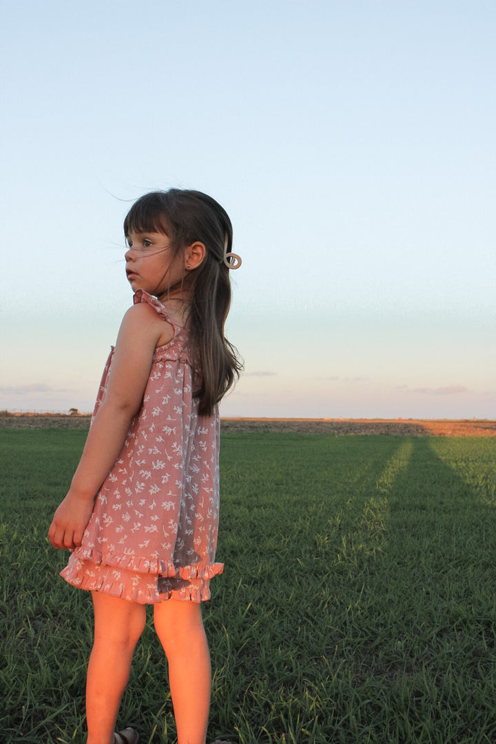 Child wearing Kids' Organic Muslin Summer Dress in Desert Rose Leaves.