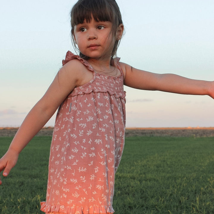 Child wearing Kids' Organic Muslin Summer Dress in Desert Rose Leaves.