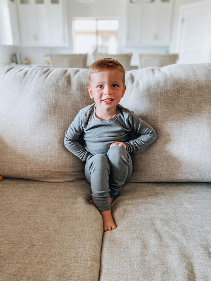Child wearing Organic Kids' L/Sleeve PJ Set in Gray.