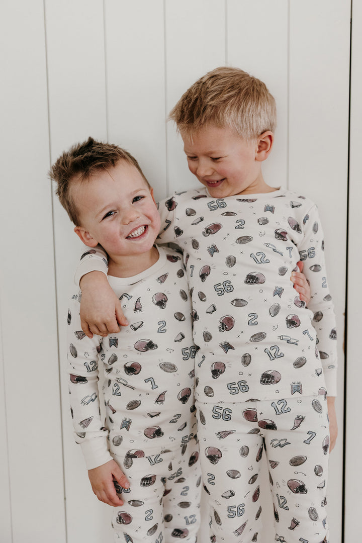 Child wearing Kids' Organic L/Sleeve PJ Set in Touchdown.
