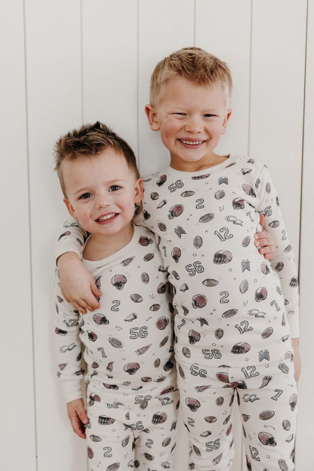 Child wearing Kids' Organic L/Sleeve PJ Set in Touchdown.