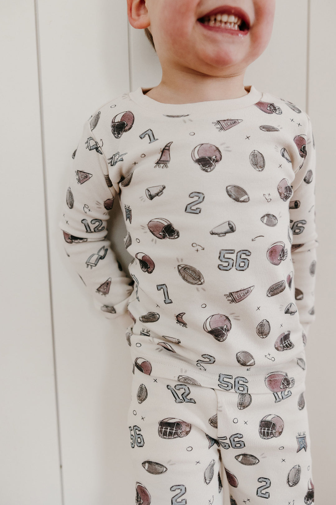 Child wearing Kids' Organic L/Sleeve PJ Set in Touchdown.