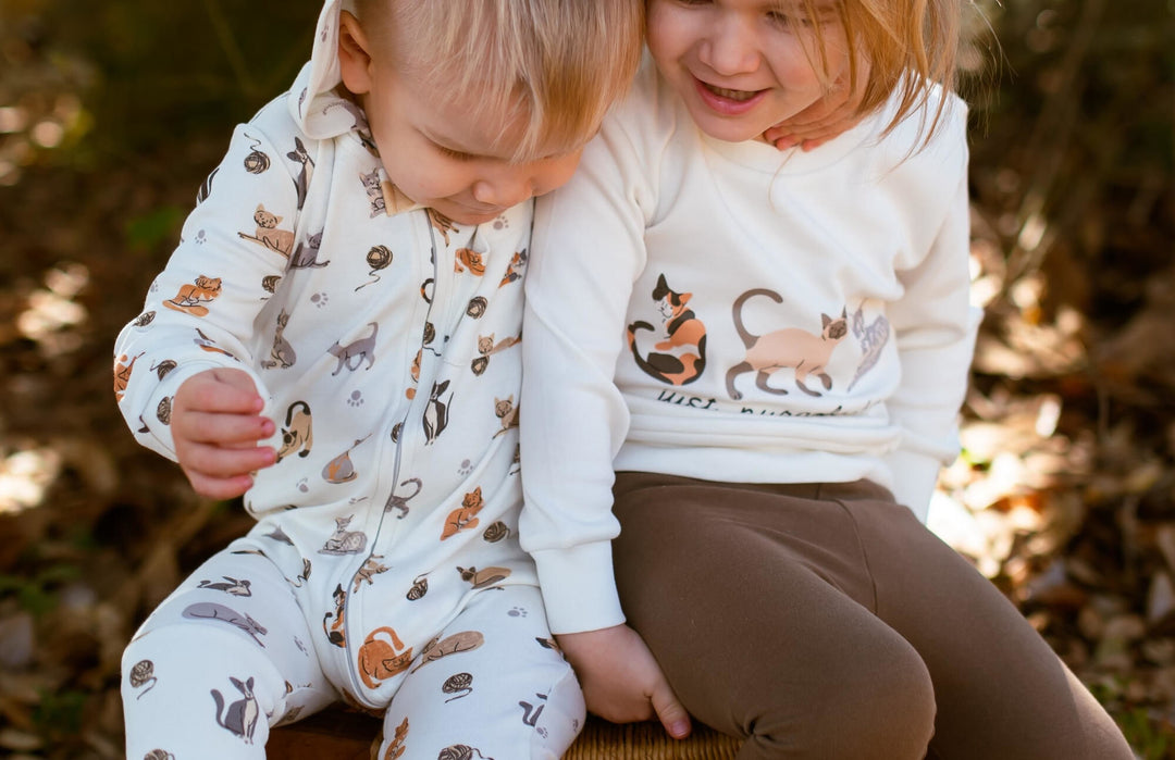 Child wearing Kids' Organic Crewneck Sweatshirt in 9 Lives.