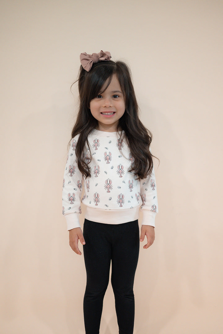 Child wearing Kids' Organic Crewneck Sweatshirt in Lobster.