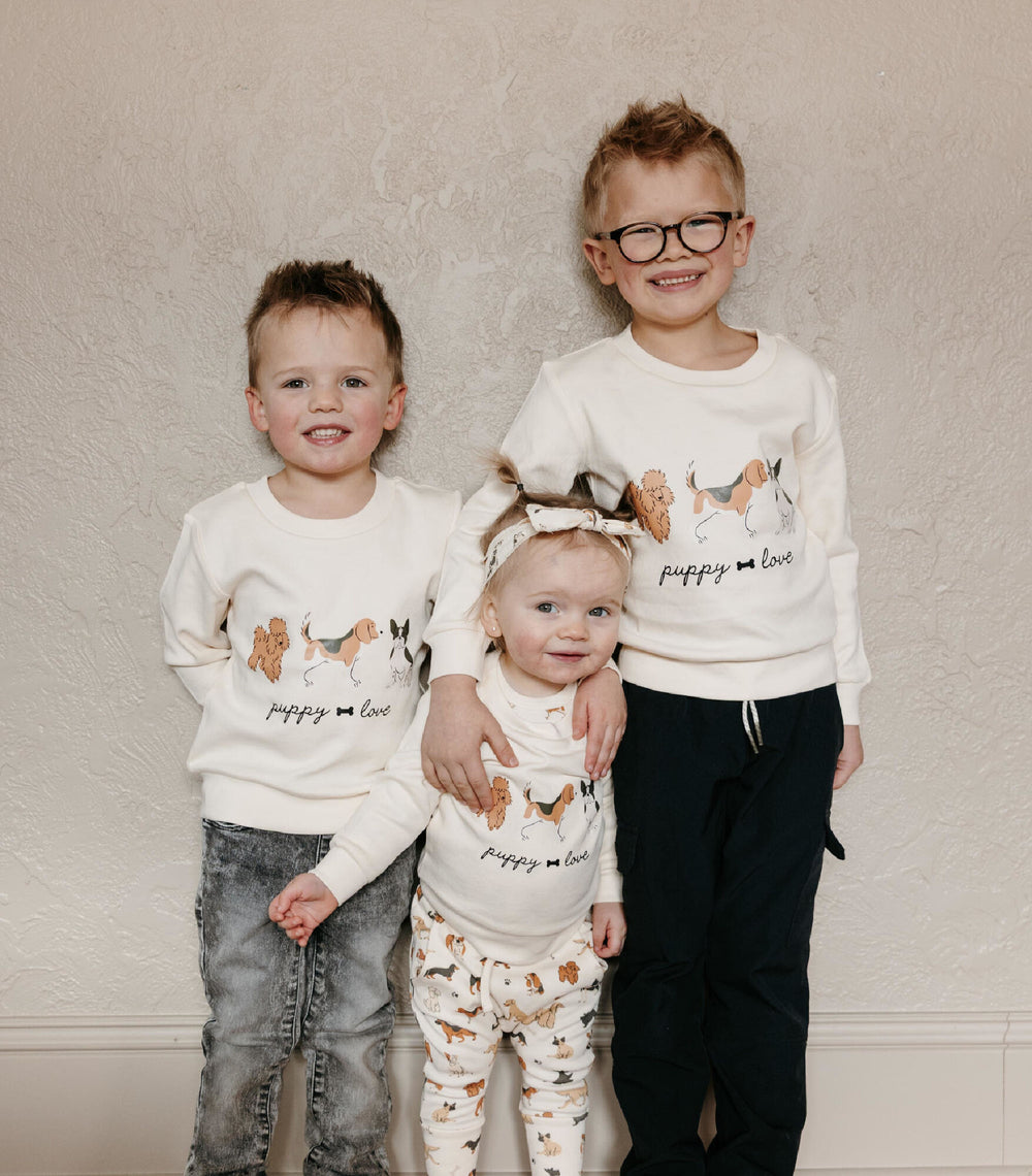 Child wearing Kids' Organic Crewneck Sweatshirt in Puppy Love.