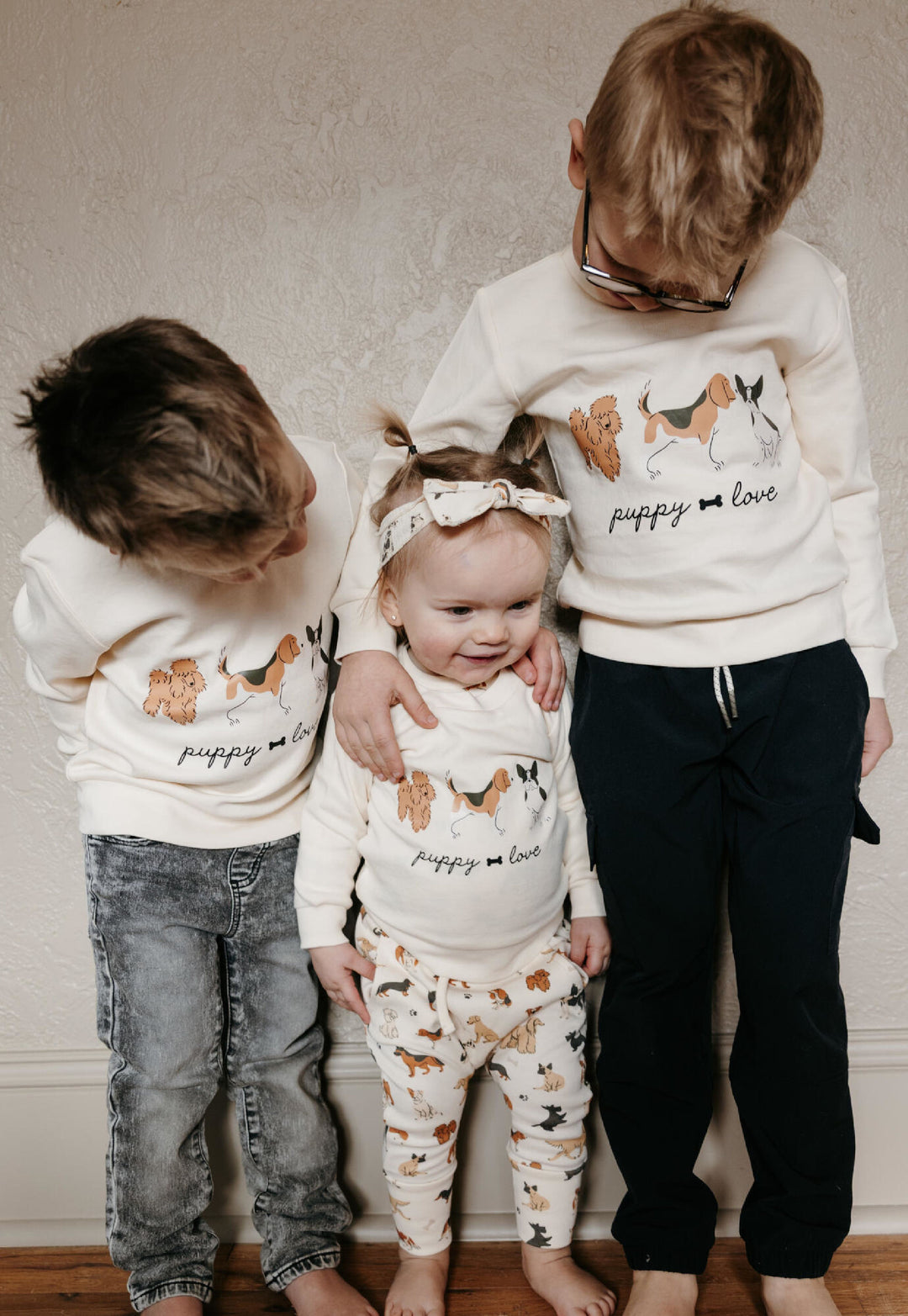 Child wearing Kids' Organic Crewneck Sweatshirt in Puppy Love.