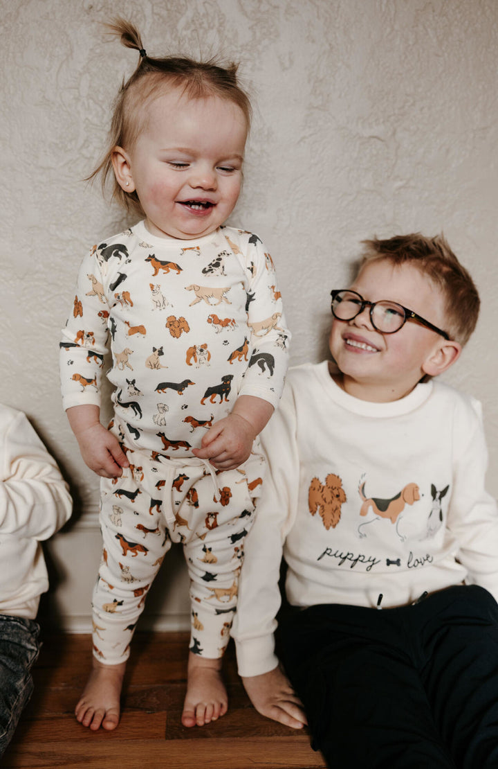 Child wearing Kids' Organic Crewneck Sweatshirt in Puppy Love.