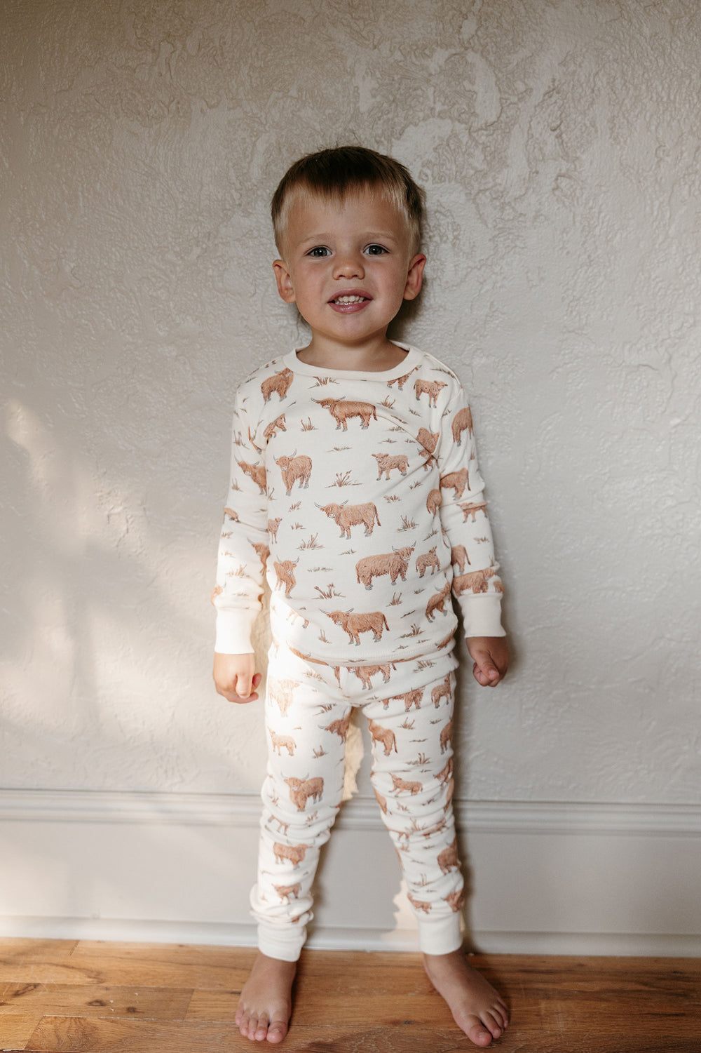 Child wearing Kids' Organic L/Sleeve PJ Set in Highland Cow.