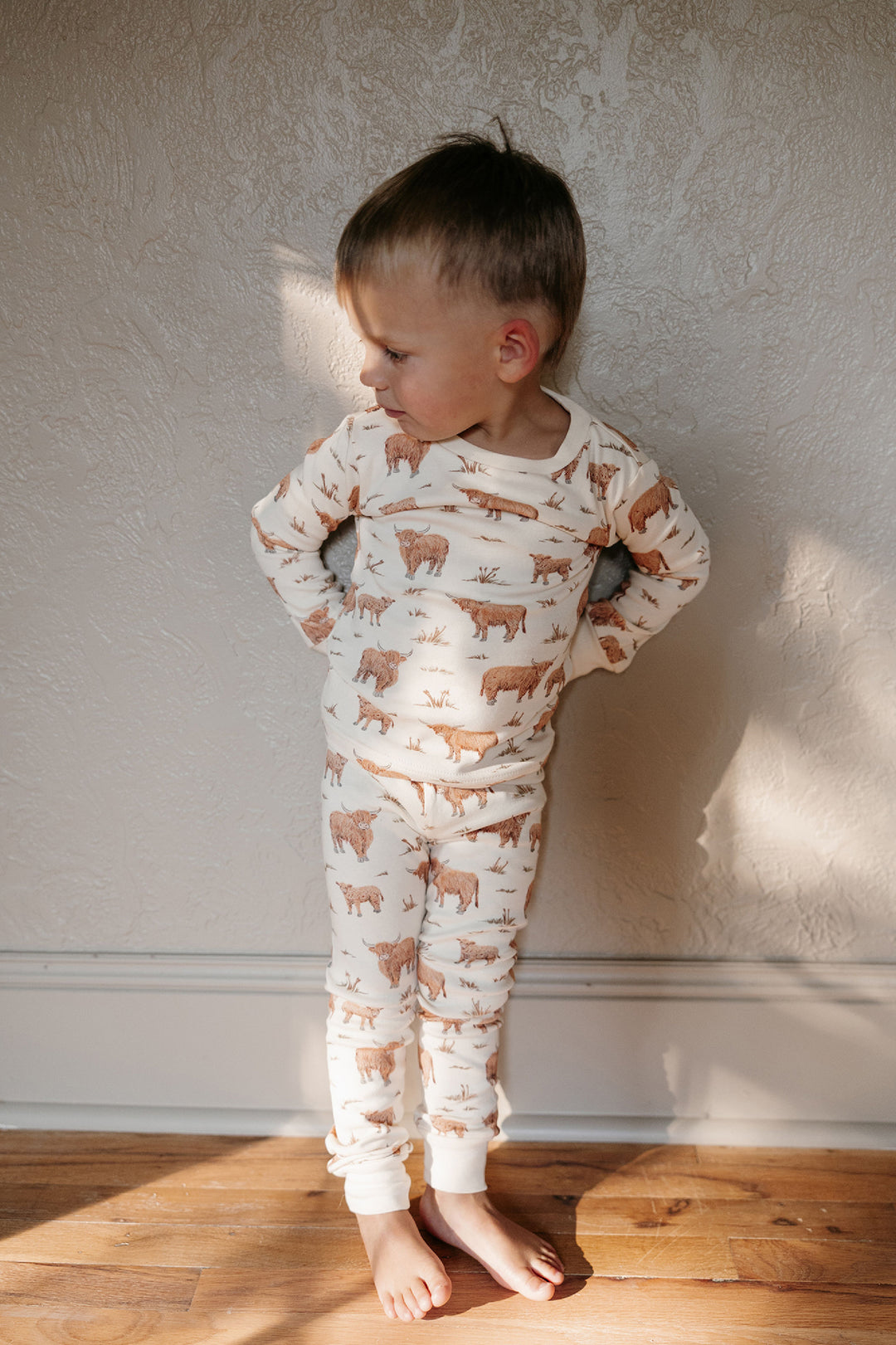 Child wearing Kids' Organic L/Sleeve PJ Set in Highland Cow.