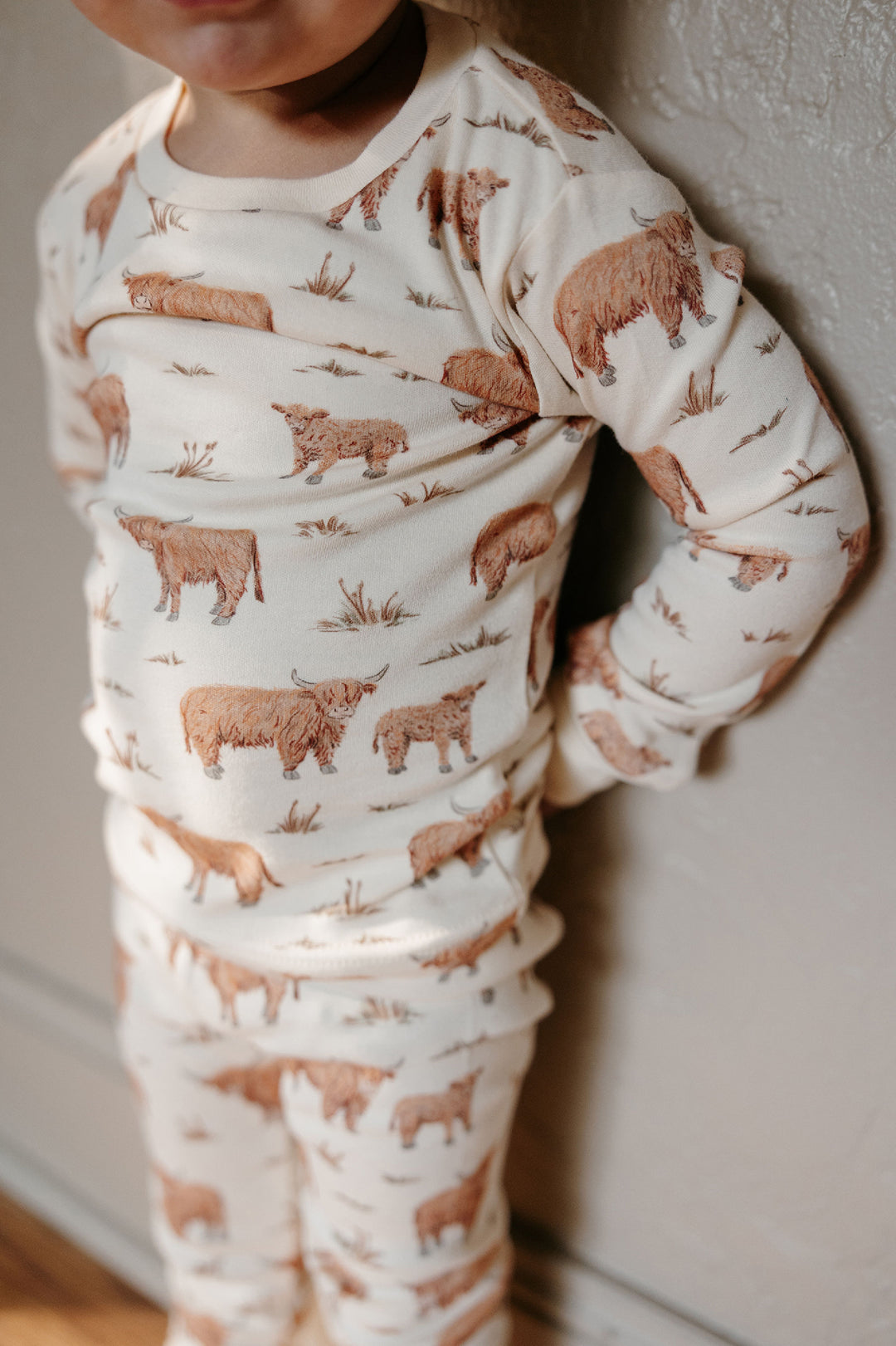 Child wearing Kids' Organic L/Sleeve PJ Set in Highland Cow.