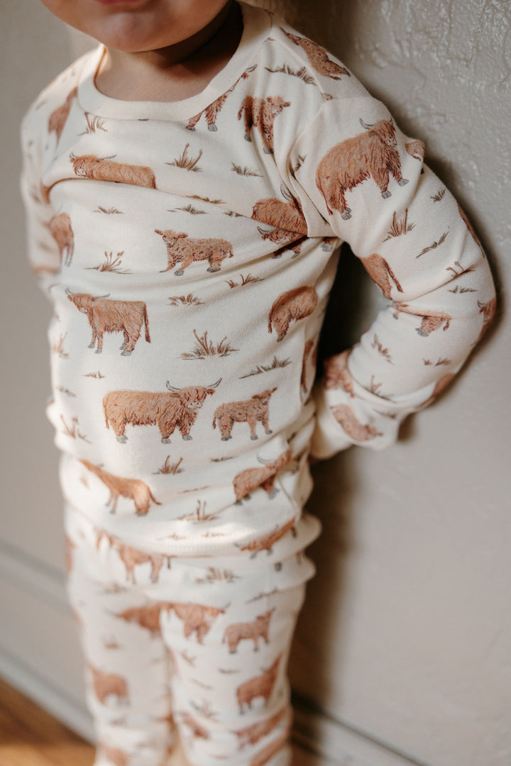 Child wearing Kids' Organic L/Sleeve PJ Set in Highland Cow.