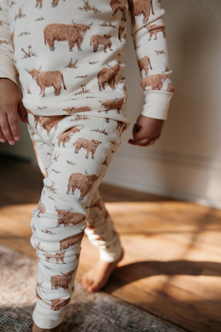 Child wearing Kids' Organic L/Sleeve PJ Set in Highland Cow.