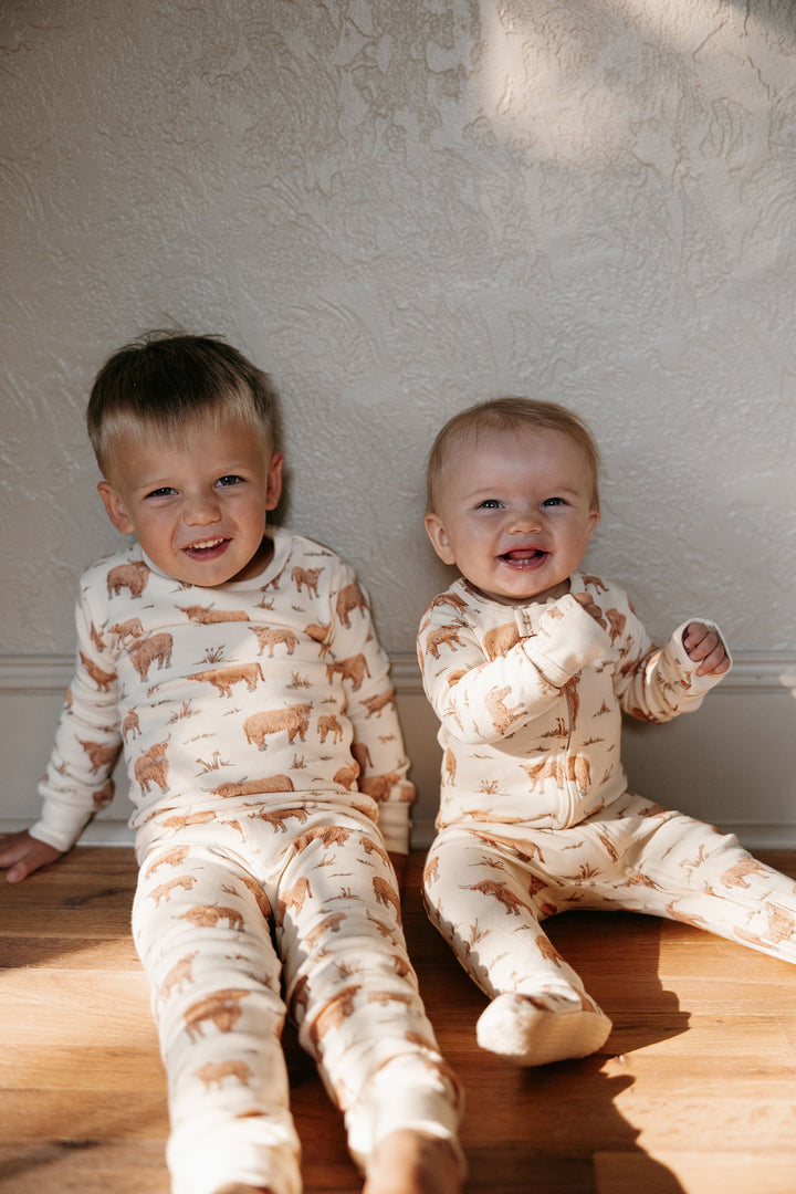 Child wearing Kids' Organic L/Sleeve PJ Set in Highland Cow.