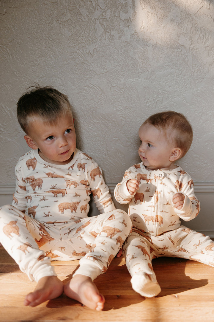 Child wearing Kids' Organic L/Sleeve PJ Set in Highland Cow.